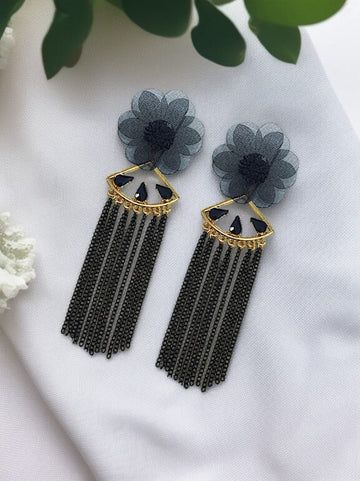Dangling from the flower is a gold-tone, fan-shaped