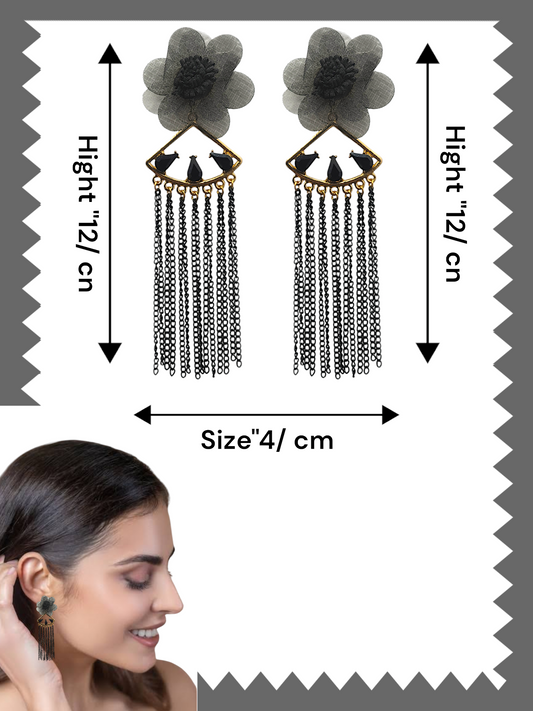 Dangling from the flower is a gold-tone, fan-shaped