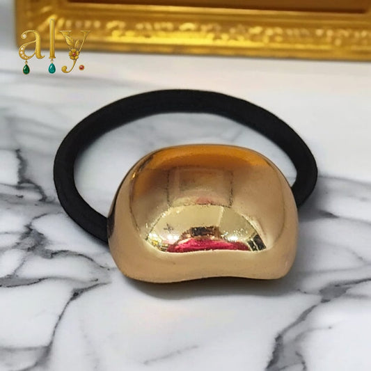 Gold-toned crescent accent.